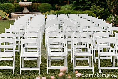 Closeup shot of the rows of chairs on the lawn outside for a wedding ceremony Stock Photo