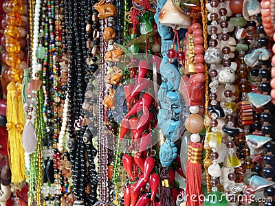 Closeup shot of rows of colorful beaded jewelry in a market Stock Photo