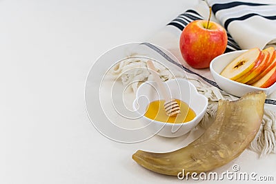 Closeup shot of the shofar, sweet honey and apples on the prayer shawl Stock Photo