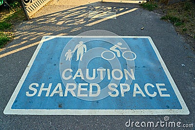 Closeup shot of a sign on the road warning about shared space for cyclists and pedestrians Stock Photo