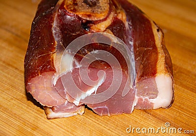 Closeup shot of a slice of smoked pork leg on a wo Stock Photo