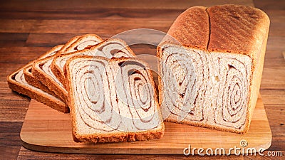 Closeup shot of slices of tasty bread on a wooden board Stock Photo