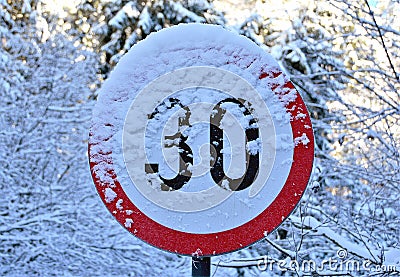 Closeup shot of a 30 speed limit indicator by covered with snow Stock Photo