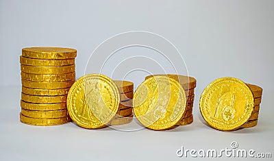 Closeup shot of stacks of gold coins isolated on a white background Stock Photo