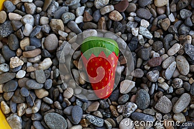 Closeup shot of a stone painted like a strawberry Stock Photo