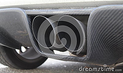 Closeup shot of a tailpipe of a car parked at a street Stock Photo