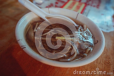 Closeup shot of a Taiwanese Oyster vermicelli soup with meat in a white bowl Stock Photo