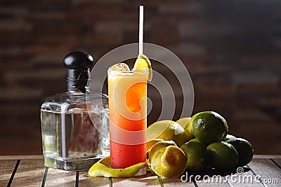 Closeup shot of Tequila Sunrise cocktail in tall glass with straw Stock Photo