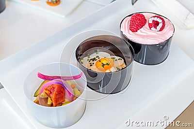 Closeup shot of three small bowls with different types of food on a white surface Stock Photo