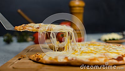 Closeup shot of triangle shape stainless steel shovel scoop piece of delicious tasty Hawaiian traditional Italian crust thin Stock Photo