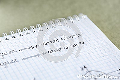 Closeup shot of trigonometric formulas written on a notebook paper Stock Photo