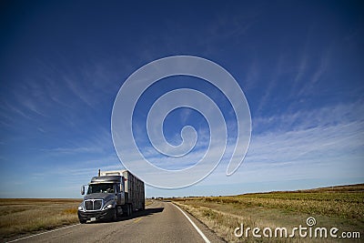Closeup shot of a truck driving on the empty roads in middle America Editorial Stock Photo