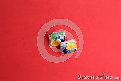 Closeup shot of the two dishwasher tablets on a red background Stock Photo