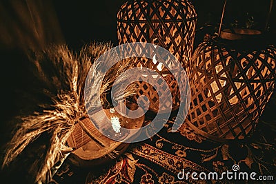 Closeup shot of two wooden lampshades with lightbulbs inside them on a table Stock Photo