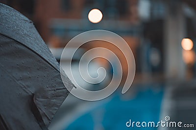 Closeup shot of an umbrella covered with raindrops on a blurred background Stock Photo