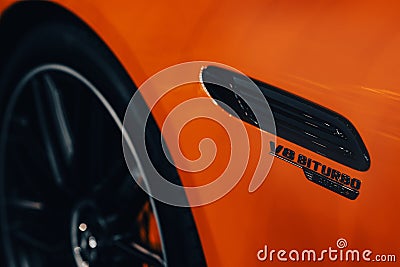 Closeup shot of the V8 BITURBO on a luxury Mercedes-Benz AMG SL with orange color Editorial Stock Photo