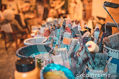 Closeup shot of various paintbrushes, tubes of paint, artistic tools and equipment in a studio Stock Photo