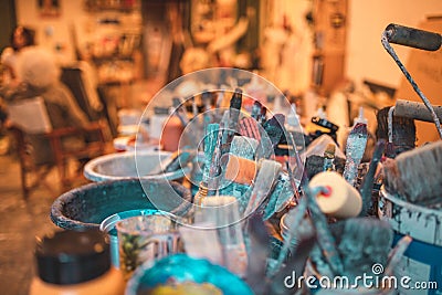 Closeup shot of various paintbrushes, tubes of paint, artistic tools and equipment in a studio Stock Photo