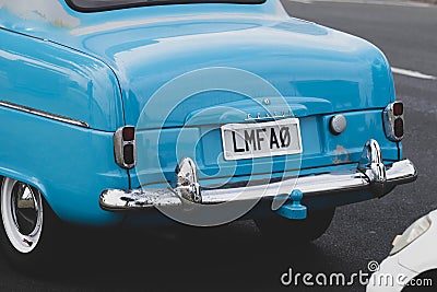 Closeup shot of a vintage blue car with a LMFAO license plate Editorial Stock Photo