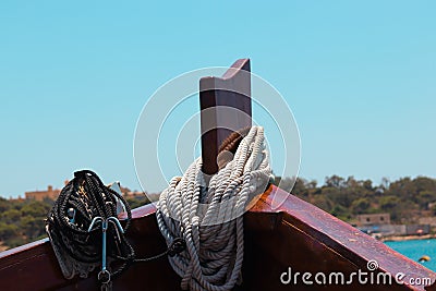 Closeup shot of a white rope rolled around a wooden stand Stock Photo