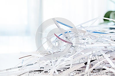 Closeup shredded white paper texture and reuse paper scrap of document with light background. Selective focus image Stock Photo