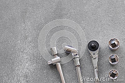 Closeup of a silver set of wrenches, nuts and bolts for changing wheels in the garage Stock Photo