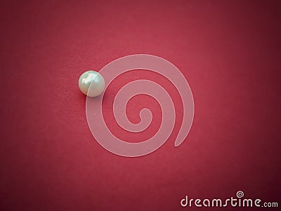 A bed or perl on red background Stock Photo