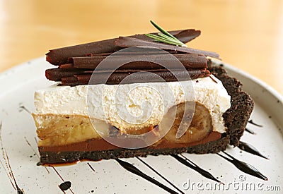 Closeup of a Slice of Banoffee Pie on White Plate Stock Photo