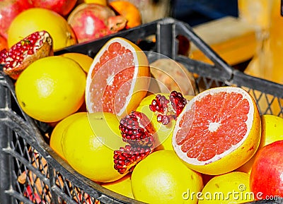 Closeup of sliced colorful fresh fruit, grapefruit and pomegranate at the streetmarket Stock Photo