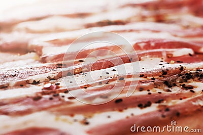 Closeup of slices of smoked pork meat with pepper Stock Photo