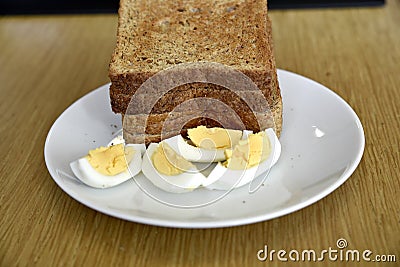 Closeup of slices of toasted whole wheat bread with boiled eggs on a plate for breakfast Stock Photo