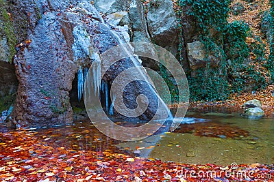 small frozen waterfall on mountain river Stock Photo