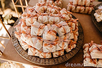 Closeup of small packs on shelves decorated with flowers indoors Stock Photo