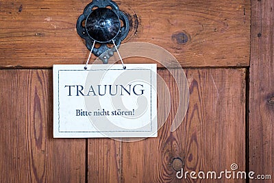 Closeup of a small sign on a door with the text: Wedding, do not disturb. Stock Photo