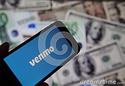 Closeup of smartphone screen with logo lettering of online money transfer service venmo, blurred banknotes background Editorial Stock Photo