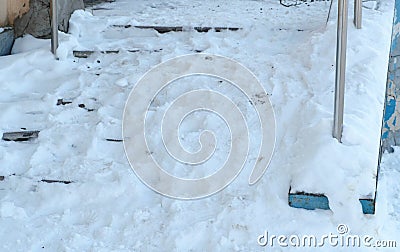 Closeup snowy slippery stairs of the porch in winter day. Camera moving from bottom to up. Stock Photo