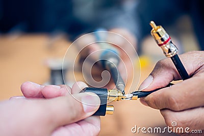 Engineer soldering audio cable Stock Photo