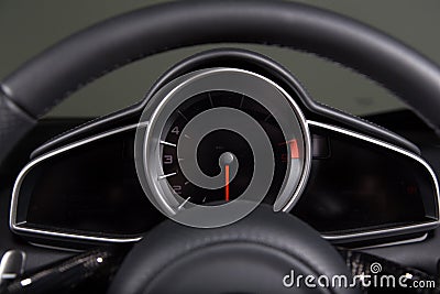 Closeup of a speedometer and a steering wheel of a modern car under the lights Stock Photo