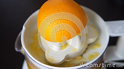 Closeup of a squeezed orange on a juicer Stock Photo