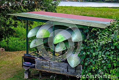 Closeup of stacked small fishing boats in a field under the sunlight at daytime Stock Photo