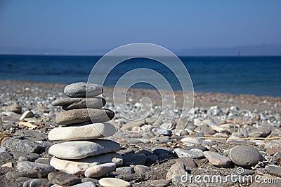 Closeup of stacked stones on the coast of the Aegean Sea on a Greek island named Kos Stock Photo