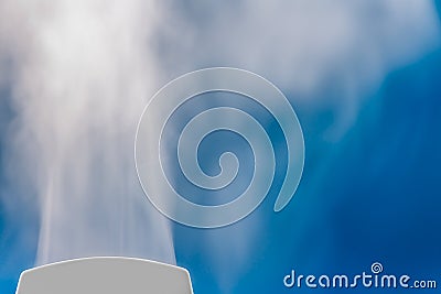 closeup steam from the air humidifier on blue background. health, disease prevention Stock Photo