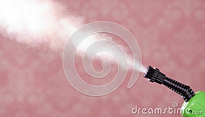 Closeup steam exiting nozzle of vapor cleaning machine, pink background Stock Photo