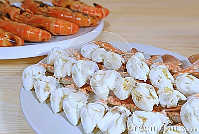 Closeup Steamed Flower Crab Legs with Blurry Flame Grilled River Prawns Served on Wooden Table Stock Photo