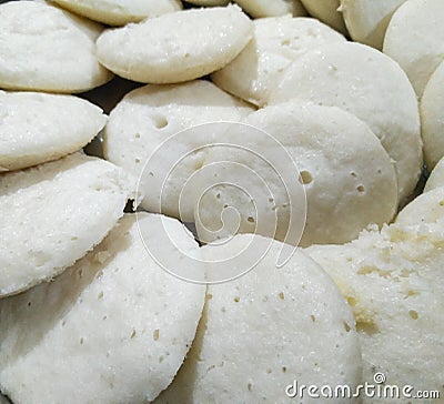 Closeup of steamed rice pancakes in a plate isolated from black vignettes, food photography, Indian cuisine, rice meals Stock Photo