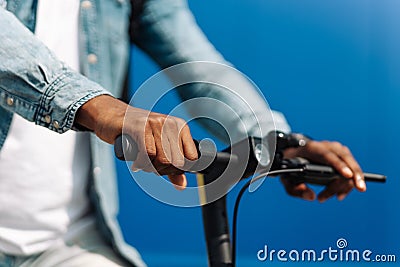Closeup steering wheel of an electric scooter man rides outdoors Stock Photo