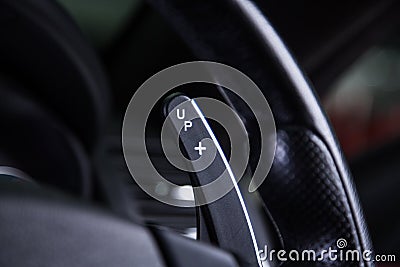 Closeup of a steering wheel of a modern luxury car under the lights Stock Photo