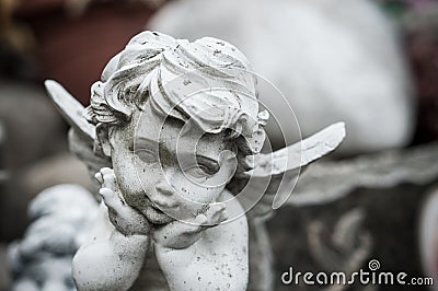 Stoned angel on tomb in cemetery Stock Photo