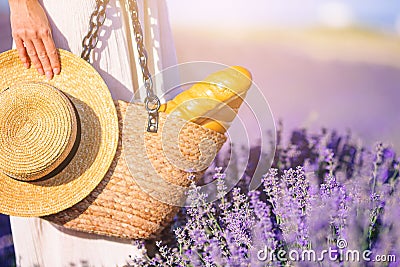 Closeup straw bag and hat in lavender field Stock Photo