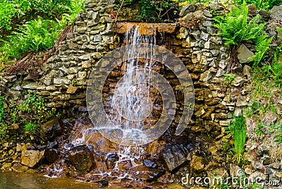 Closeup of a streaming waterfall, beautiful garden architecture, Nature background Stock Photo